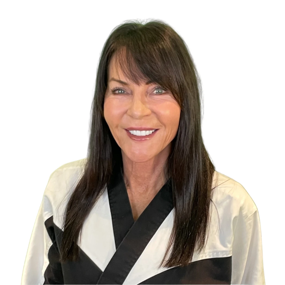 Jan Stockton is smiling confidently in a white and black martial arts uniform (gi) against a white background.